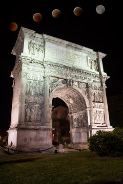 The Arch of Trajan in the night in Benevento (Italy) with total eclipse of moon
