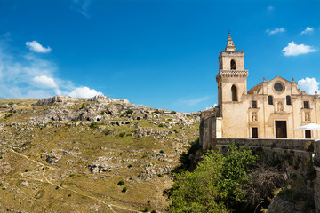 Fototapeta na wymiar Church of San Pietro Caveoso in the old area of Matera and in the background the hill with the caves