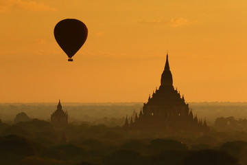  The hot air balloon over plain for tourist and beautiful landscape pagoda ancient with misty morning time of Burma. The landmark tourism culture in Asian.