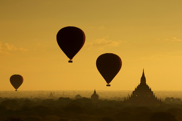  The hot air balloon over plain for tourist and beautiful landscape pagoda ancient with misty morning time of Burma. The landmark tourism culture in Asian.