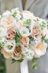 spring mood. Young girl holding a beautiful wedding bouquet. flower arrangement with white and Pastel color flowers.