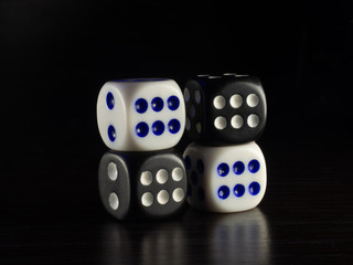 Table gambling with dice and backgammon in the evening with dim light on a dark background