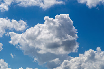 White fluffy clouds in the blue sky background