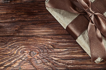 Brown wrapped present box on vintage board