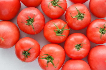 Ripe red tomatoes on a gray stone background, top view