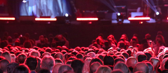 heads of people during live outdoor concert with many lights on