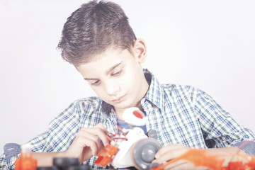 STEM education concept with little boy building a robot