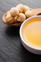 delicious macadamia nuts on a dark stone background