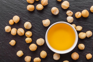 delicious macadamia nuts on a dark stone background