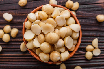 delicious macadamia nuts on a wooden rustic background