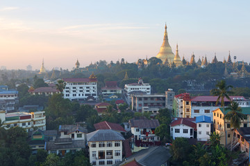 Shwedagon Pagoda Temple with village below in the during sunrise at Yangon, Myanmar (Burma)