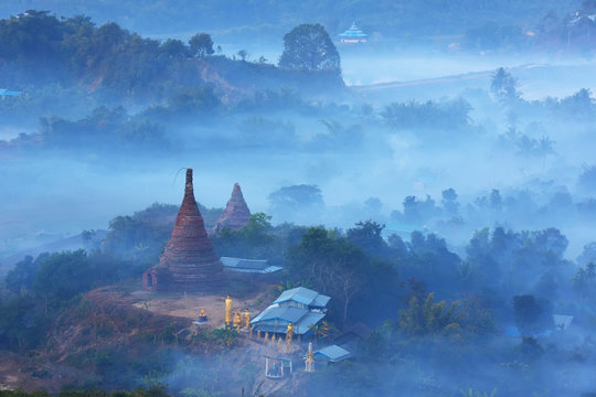 Sunrise over pagodas of Mrauk U in the misty at the northern Rakhine State, Myanmar  (Burma)