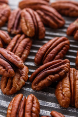delicious pecan nuts on a rustic wooden background