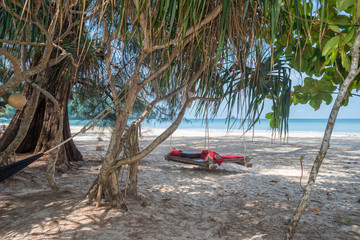 Hammock and swing bed under screw palms at the Ao Yai beach on Ko Phayam