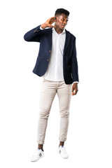 Fototapeta premium Full body of Handsome african american man wearing a jacket listening to something by putting hand on the ear on white background