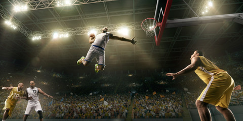 Basketball players on big professional arena during the game. Basketball player makes slum dunk. Bottom view