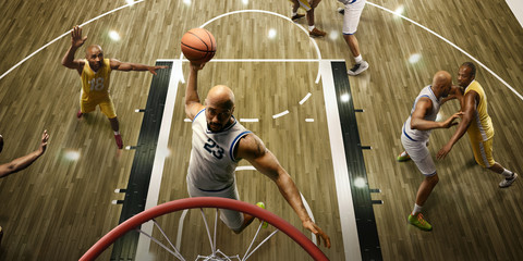 Basketball players on big professional arena during the game. Basketball player makes slum dunk....