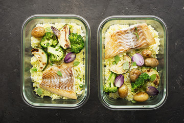A healthy meal for a snack is a lunch box. Glass containers with fresh steam sea fish, rice with...