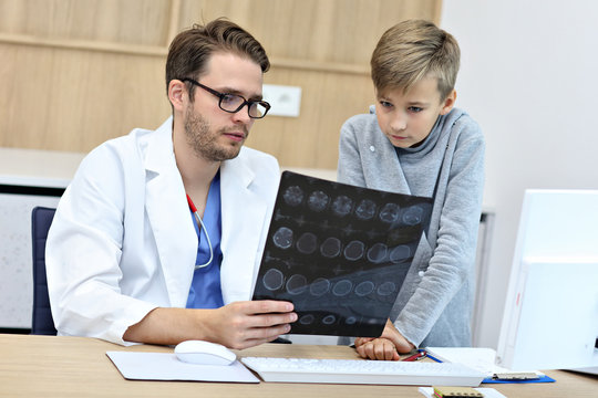 Little boy in clinic having a checkup with pediatrician - Powered by Adobe