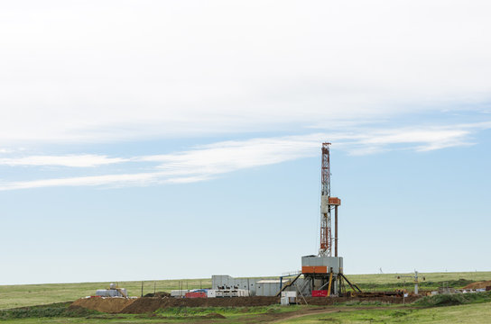 Drilling tower in the steppe. Steppe landscape with drilling rigs and equipment