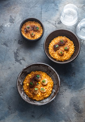 Pumpkin risotto in a table on stone background