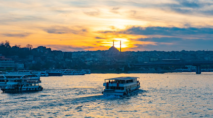 Fototapeta premium Tourist boat in Golden Horn Istanbul at sunset, Turkey