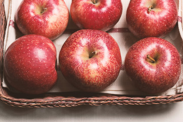 red yellow apples in a basket woven from the vine