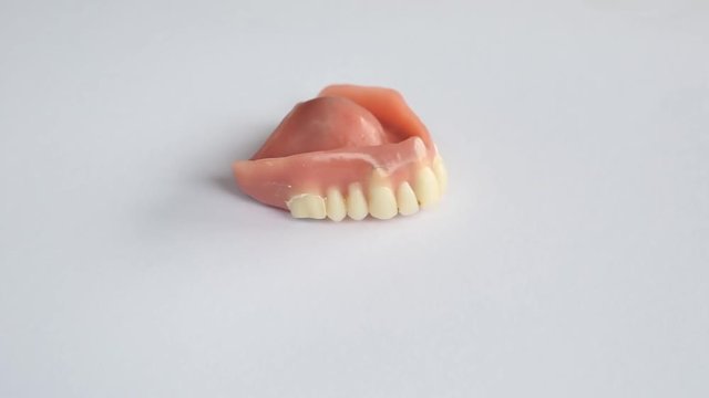 Dentures on a rotating white plate
