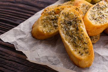 fragrant garlic bread on a rustic wooden background