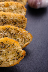 fragrant garlic bread on a dark stone plate