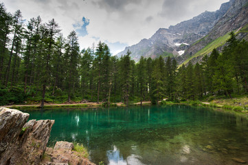 alpine lake Pellaud in a pine forest Rhemes Notre Dame, Valle dAosta, Italy