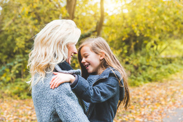 Fototapeta premium Mother and daughter playing and looking each other at park