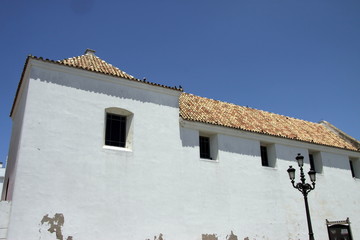 Fragment of a building with a tiled roof in the old maritime city-fortress of Cadiz.
