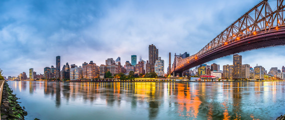 New York, New York, USA skyline of Manhattan from across the East River with Queensboro Bridge at...
