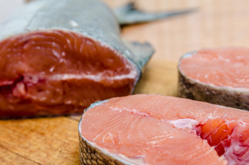Fish chum salmon on a cutting Board and a steak of red fish