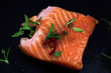 Fresh raw salmon fish on black background, seafood recipe menu 