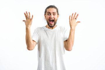 Naklejka premium Happy man raised his hands in delight. A young man shows ten fingers. Very good is a positive emotion.