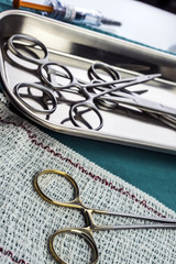 Some scissors for surgery on a tray in an operating theater, conceptual image