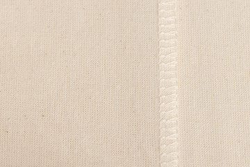 inner sewing seam on white linen cloth, as background