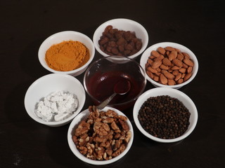 Turmeric,Limestone,Chuna,Almonds, Badam,Kali Mirch, Black Pepper,Kismish,Raisns,Haldi,Red Paste for Knee pain, Medicine for Knee Pain,Honey, Honey in Glass Jar, Wooden Background