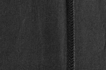 inner sewing seam on black linen cloth, as background