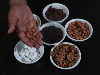 Turmeric, Kismish, Almonds, Badam, Akhrot, Walnuts, Chuna, Limestone, Haldi, Black Pepper, Kali Mirch, Wooden Background,