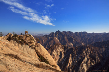 Huashan Scenery, Mount Hua - Huayin, near Xi'an in Shaanxi Province China. Chess Playing Pavilion, Pagoda at the top of a Cliff with Steep Vertical Drop-off, yellow granite mountains of China. 华山