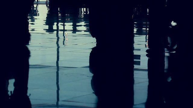 Timelapse Shadows Of People Walking Or Waiting In The Airport Terminal, Reflections Of Travelers On The Tiled Floor - HD Video