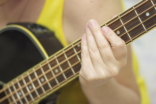 Woman holding an acoustic bass guitar