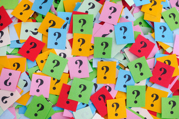 Big pile of colorful paper notes with question marks