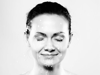 Portrait of a young woman with drops of milk on her