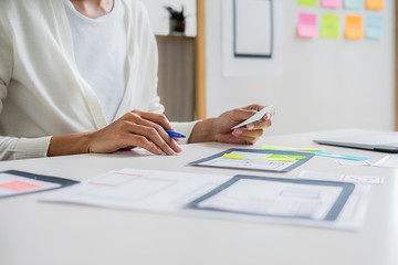 Creative Web Designer planning application and developing template layout, framework for mobile phone. User experience (UX) concept.