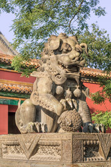 Guardian Lion in front of an ornamented pavilion at Yonghe Lamasery, also known as Lama Temple, monastery of the Gelug school of Tibetan Buddhism located in Dongcheng District.