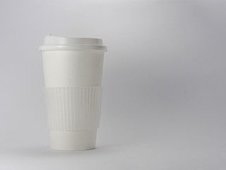 Takeaway blank paper coffee cup mock up with cup lid and sleeve isolated on white background.Recyclable disposable tableware is not eco-friendly to the earth often used for hot drink in food store.